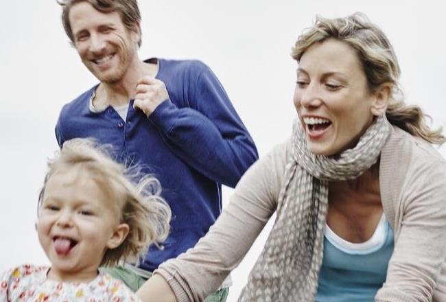 Close-up of a happy family on a walk outside.